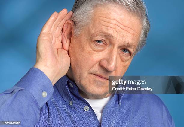 man with hearing difficulties - deafness stock pictures, royalty-free photos & images