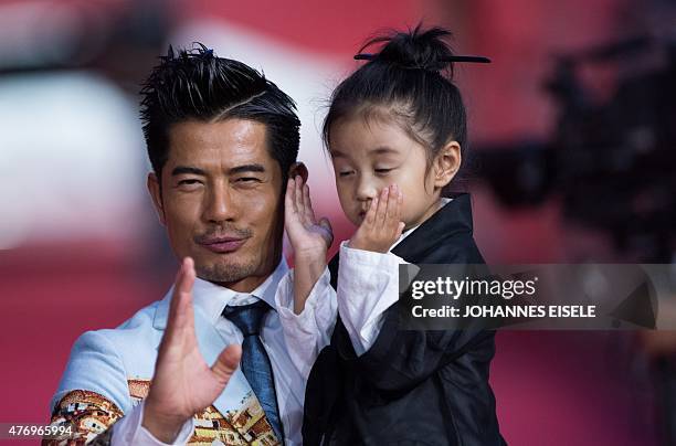 Hong Kong Actor Aaron Kwok poses on the red carpet during the opening ceremony of the Shanghai International Film Festival in Shanghai on June 13,...