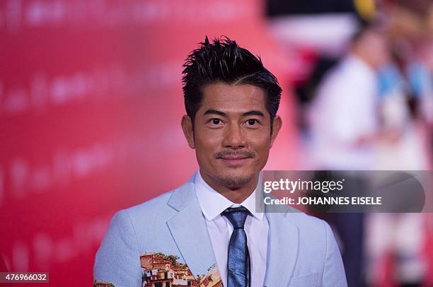 Hong Kong Actor Aaron Kwok poses on the red carpet during the opening ceremony of the Shanghai International Film Festival in Shanghai on June 13,...