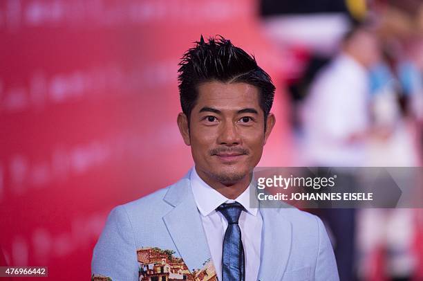 Hong Kong Actor Aaron Kwok poses on the red carpet during the opening ceremony of the Shanghai International Film Festival in Shanghai on June 13,...