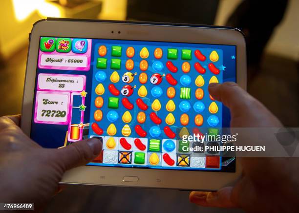 Person plays on his tablet with Candy Crush Saga games developed by British King Digital Entertainment, on March 6 in Lille, northern France. The...