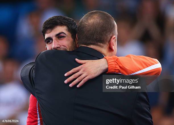 Firdovsi Farzaliyev of Azerbaijan is presented with his gold medal by President of Azerbaijan Ilham Aliyev during the medal ceremony for the Men's...