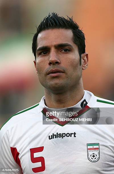 Iran's Amir Hossein Sadeghi of Iran's Esteghlal club listens to the national anthem before the international friendly football match Guinea versus...