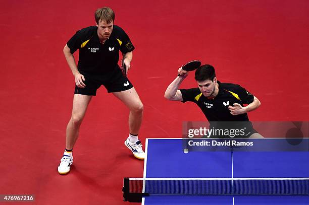 Patrick Baum and Dimitrij Ovtcharov of Germany compete in the Table Tennis - Men's Team's first round match against Marc Duran and Alvaro Robles of...