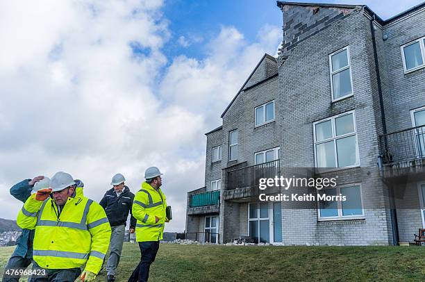 Aberystwyth Wales UK, Thursday 13 Feb 2014 Police and CANTREF Housing Association officers are evacuating tenants and owners of flats in the PLAS...