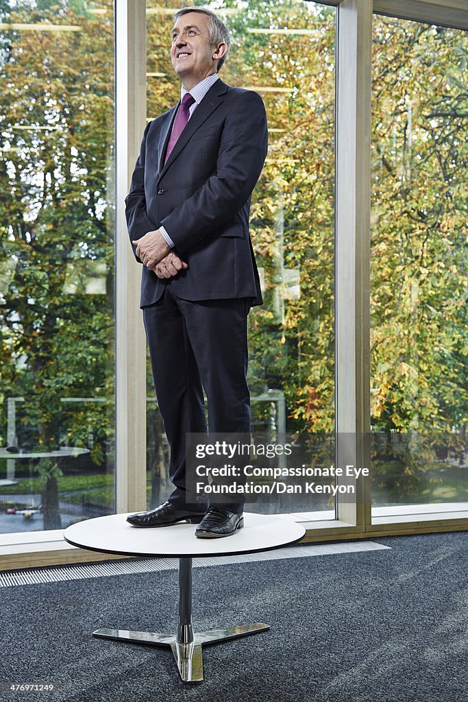 Portrait of businessman standing on table