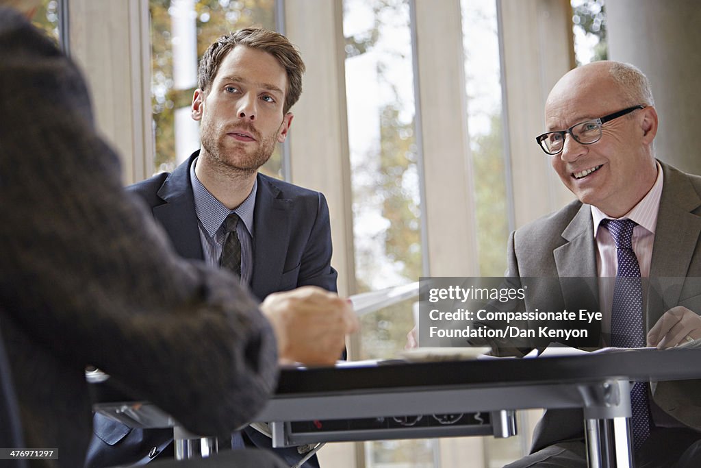 Three business people in meeting