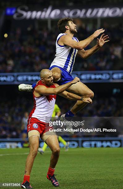 Jarrad Waite of the Kangaroos marks the ball over Rhyce Shaw of the Swans during the round 11 AFL match between the North Melbourne Kangaroos and the...