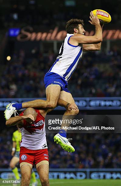 Jarrad Waite of the Kangaroos marks the ball over Rhyce Shaw of the Swans during the round 11 AFL match between the North Melbourne Kangaroos and the...