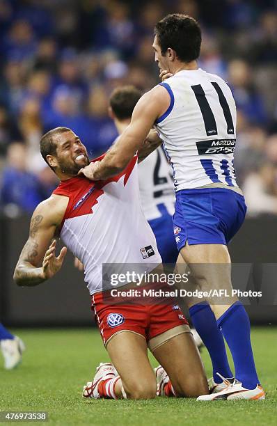 Lance Franklin of the Swans reacts after copping an eye rake from Michael Firrito of the Kangaroos during the round 11 AFL match between the North...