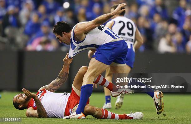 Lance Franklin of the Swans reacts after copping an eye rake from Michael Firrito of the Kangaroos during the round 11 AFL match between the North...