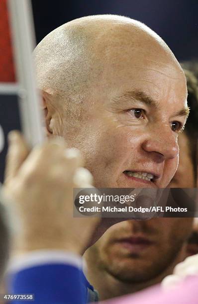 Kangaroos stand in coach Darren Crocker speaks to his players during the round 11 AFL match between the North Melbourne Kangaroos and the Sydney...