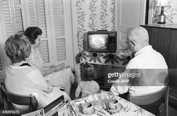 Family watches the American astronaut Neil Armstrong commander of Apollo 11, setting his foot on the moon 21 July 1969 in Paris. Hundreds of millions...