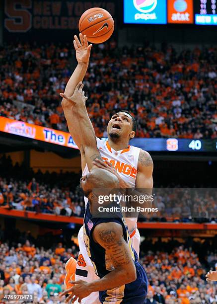 Michael Gbinije of the Syracuse Orange is fouled by Trae Golden of the Georgia Tech Yellow Jackets while taking a shot during the second half at the...