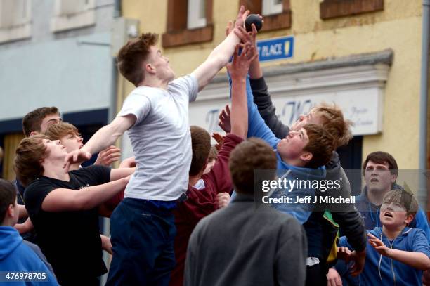 Youths chase after the leather ball during the annual 'Fastern Eve Handba' event in Jedburgh's High Street in the Scottish Borders on March 6, 2014...