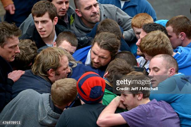 Men tussle for the leather ball during the annual 'Fastern Eve Handba' event in Jedburgh's High Street in the Scottish Borders on March 6, 2014 in...