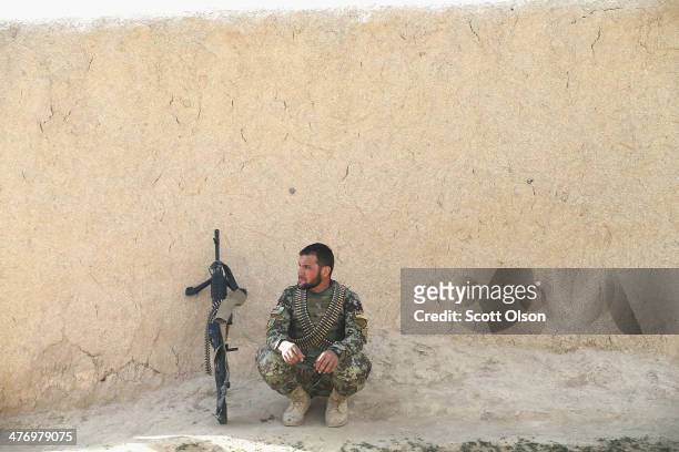 Soldier with the Afghan National Army keeps watch during a patrol through a village March 5, 2014 near Kandahar, Afghanistan. President Obama...
