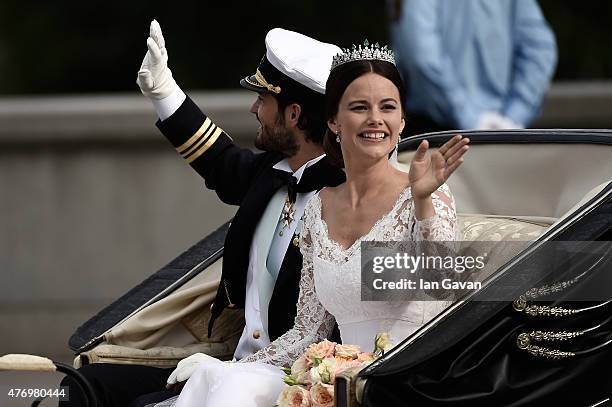 Prince Carl Philip of Sweden and his wife Princess Sofia of Sweden ride in the wedding cortege after their marriage ceremony on June 13, 2015 in...