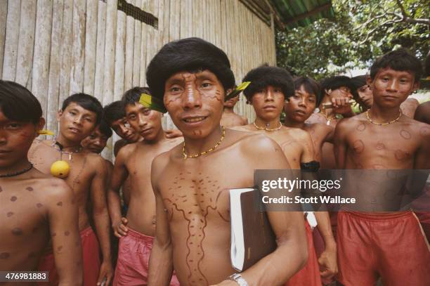 Yanomami man and teenage boys at a mission school in the Amazon rainforest of Venezuela, 2001.