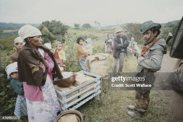 Soldiers of the Sandinista Popular Army conduct the forced evacuation of peasants, El Ventarron, Nicaragua, 1985.