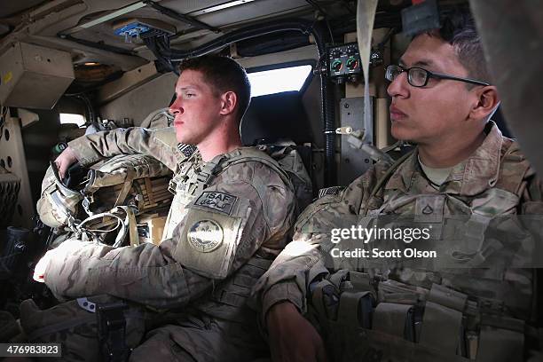 Tyler Hankins from Loves Park, Illinoi and PFC Alexander Medina from Keshena, Wisconsin with the U.S. Army's 4th squadron 2d Cavalry Regiment sit in...