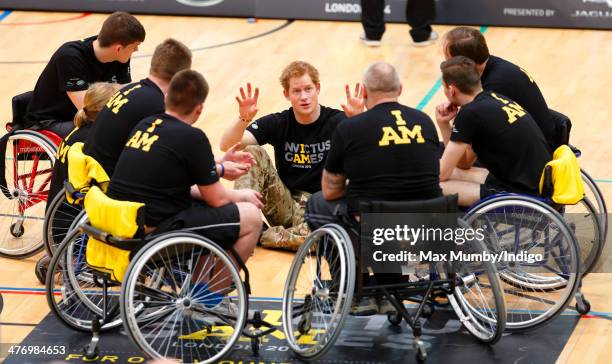 Prince Harry talks with wheelchair basketball players during the launch of the Invictus Games at the Copper Box Arena in the Queen Elizabeth Olympic...