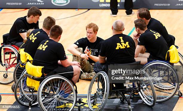 Prince Harry talks with wheelchair basketball players during the launch of the Invictus Games at the Copper Box Arena in the Queen Elizabeth Olympic...