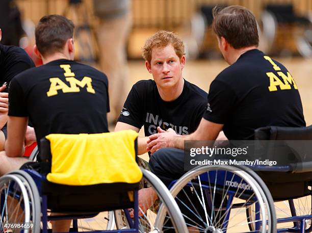 Prince Harry talks with wheelchair basketball players during the launch of the Invictus Games at the Copper Box Arena in the Queen Elizabeth Olympic...