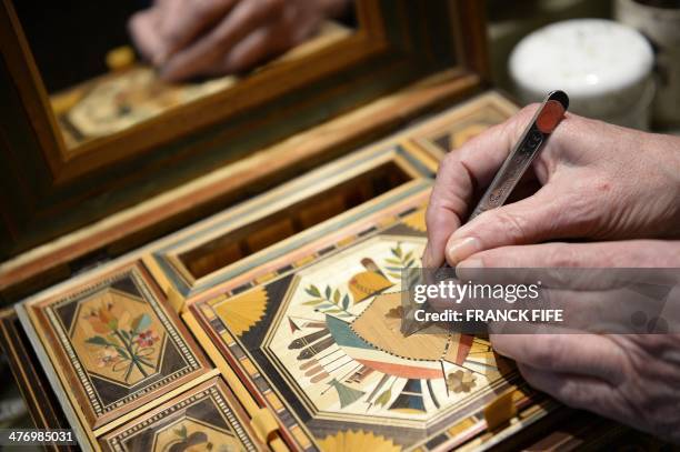 Marquetry inlayer Lison de Caunes is at work in her workshop on March 6 in Paris. Straw marquetry is a French tradition that dates back to the 17th...