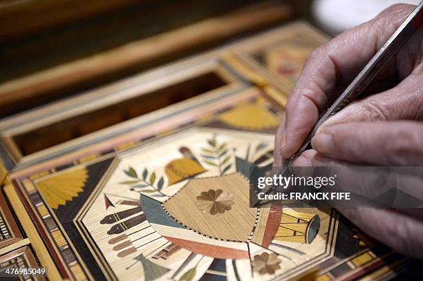 Marquetry inlayer Lison de Caunes is at work in her workshop on March 6 in Paris. Straw marquetry is a French tradition that dates back to the 17th...