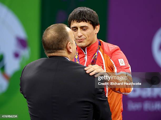 Gold medalist Rasul Chunayev of Azebaijan receives his medal won in the Men's 71kg Greco-Roman final from President of Azerbaijan Ilham Aliyev during...