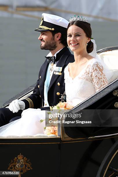 Prince Carl Philip of Sweden and his wife Princess Sofia of Sweden ride in the wedding cortege after their marriage ceremony on June 13, 2015 in...