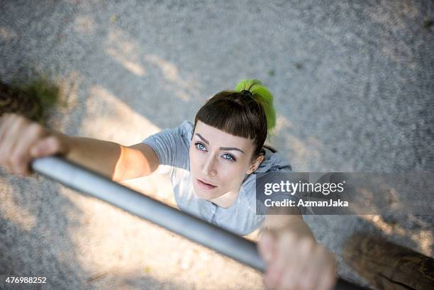 doing pullups in an outdoors park - doing pull ups stock pictures, royalty-free photos & images