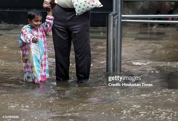 Child walks through a flooded street during heavy rain at Hindamata, Dadar on June 13, 2015 in Mumbai, India. Heavy rains caused major water logging...