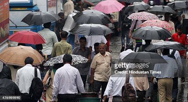 People commuting with umbrellas during heavy shower near Dadar station on June 13, 2015 in Mumbai, India. Heavy rains caused major water logging in...