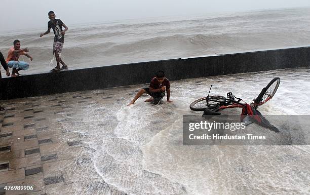 Children enjoying the high tide at Worli Sea face on June 13, 2015 in Mumbai, India. Heavy rains caused major water logging in many areas on...