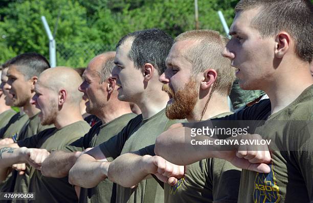 Recruits of the Ukrainian Azov regiment line-up after their final tests at a base in Kiev on June 13, 2015 before a departure to the east of Ukraine....