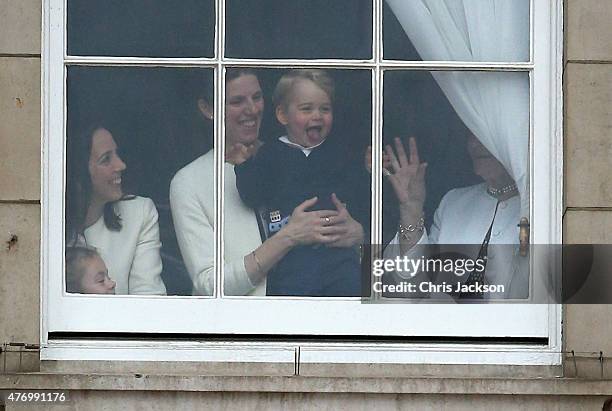 Prince George of Cambridge is held by his nanny Maria Teresa Turrion Borrallo as he waves from the window of Buckingham Palace as he watches the...