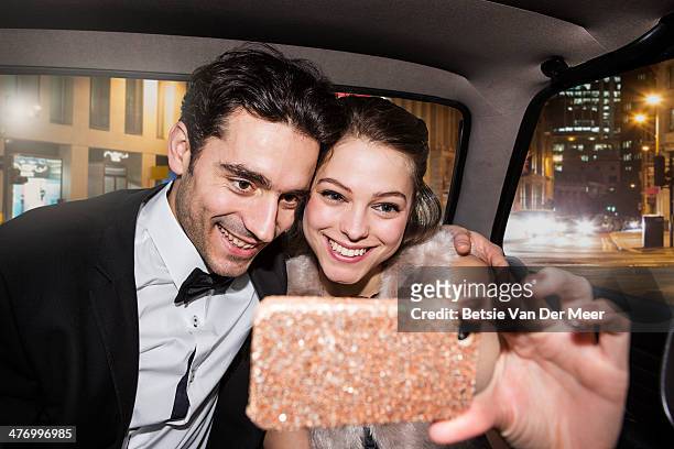 couple taking self portrait on phone in car. - white tie stock pictures, royalty-free photos & images