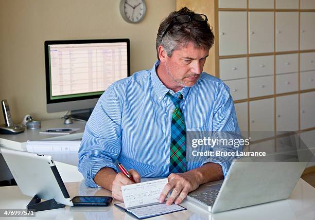 Man Write Check Senior Writing A Check Photos and Premium High Res Pictures - Getty Images