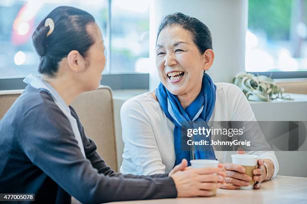 senior japanese woman laughing with a friend - japanese old woman stockfoto's en -beelden