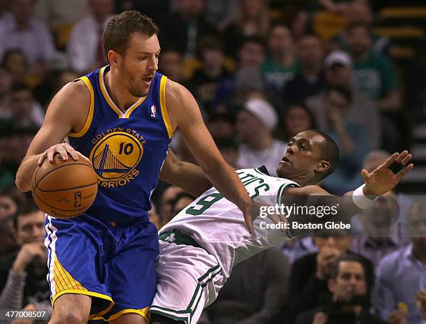 Boston Celtics point guard Rajon Rondo takes an offensive charge from Golden State Warriors power forward David Lee in the first half. The Boston...