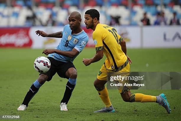 Diego Rolan of Uruguay fights for the ball with Jobi McAnuff of Jamaica during the 2015 Copa America Chile Group B match between Uruguay and Jamaica...