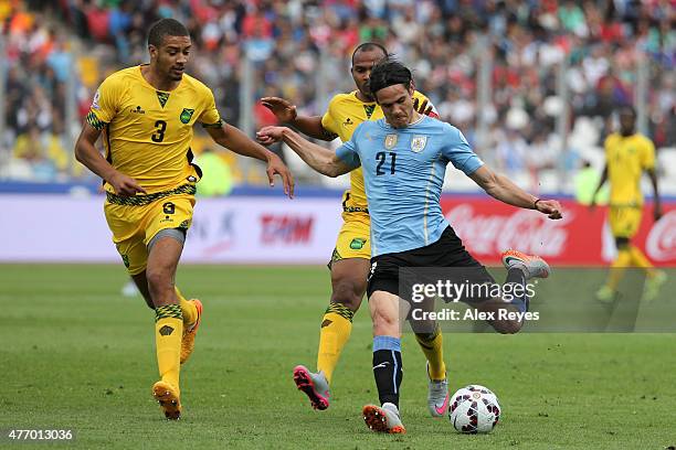 Edinson Cavani of Uruguay kicks the ball while is followeb by Michael Hector of Jamaica during the 2015 Copa America Chile Group B match between...