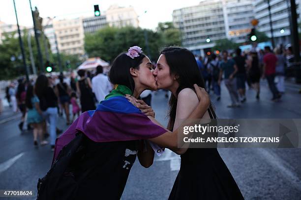 Two womn kiss as they take part in the annual Gay Pride parade in Athens, on June 13, 2015. Greece's radical-left government on June 10 proposed a...