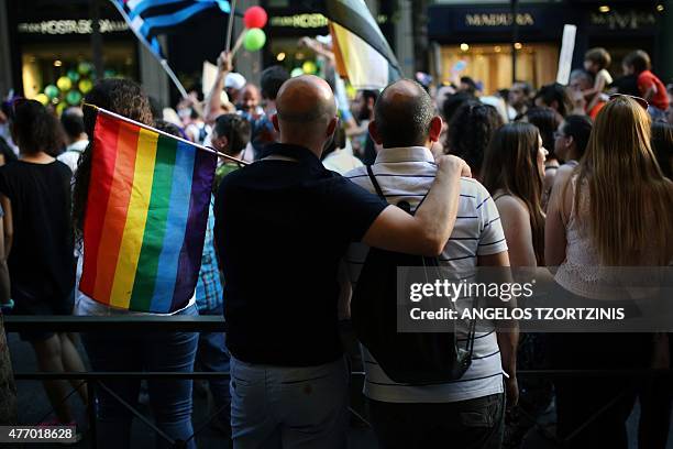 Two men take part in the annual Gay Pride parade in Athens, on June 13, 2015. Greece's radical-left government on June 10 proposed a bill to grant...