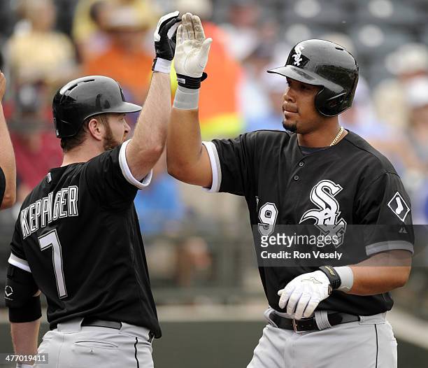 Jose Abreu of the Chicago White Sox is greeted by Jeff Keppinger after hitting a two-run home run, his first as a member of the Chicago White Sox,...