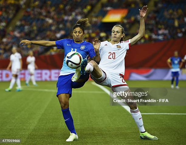 Cristiane of Brazil is challenged by Irene Paredes of Spain during the FIFA Women's World Cup 2015 group E match between Brazil and Spain at Olympic...