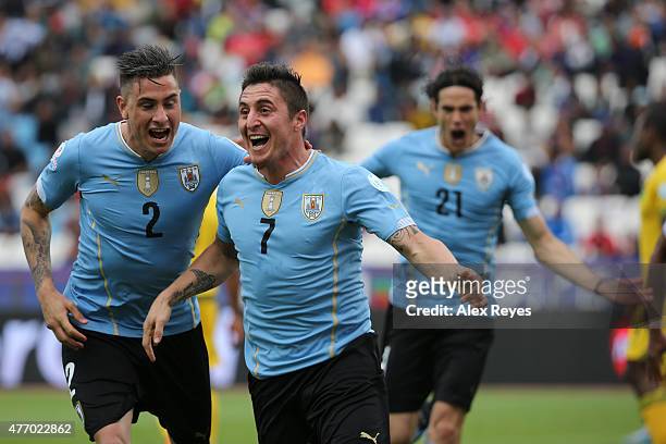 Cristian Rodriguez of Uruguay celebrates with teammate Jose Maria Gimenez after scoring the opening goal during the 2015 Copa America Chile Group B...