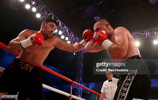 Young Fury of Great Britain and Jindrich Velecky of Czech Republic exchange blows during their Heavyweight bout at Action Indoor Sports Arena on June...